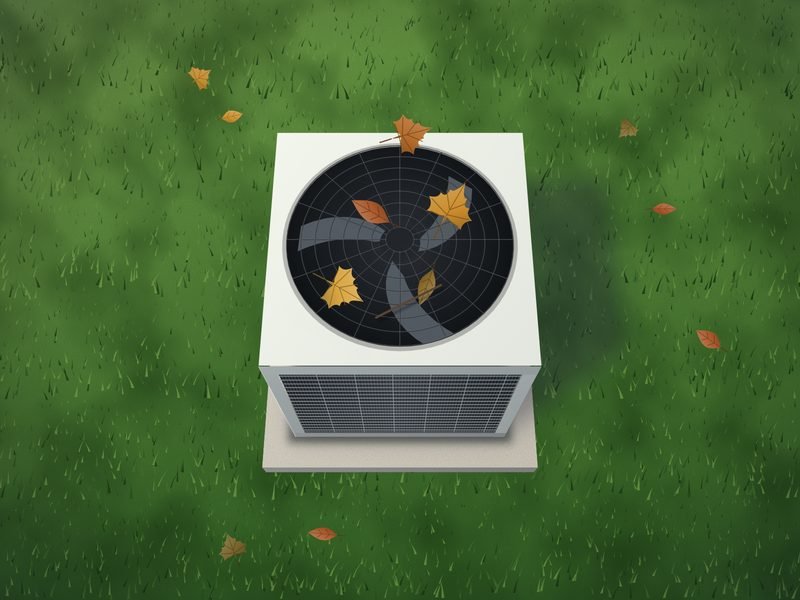 Looking down on the top of an outdoor air conditioner, showing the round fan guard with a few fallen leaves on it and grass around the unit