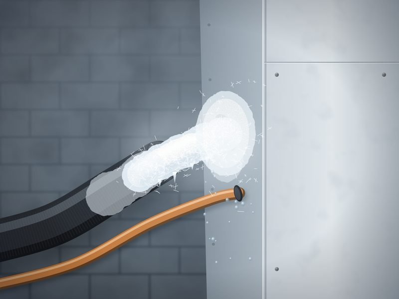 Close view of an insulated copper refrigerant line covered in white frost where it enters the indoor coil cabinet