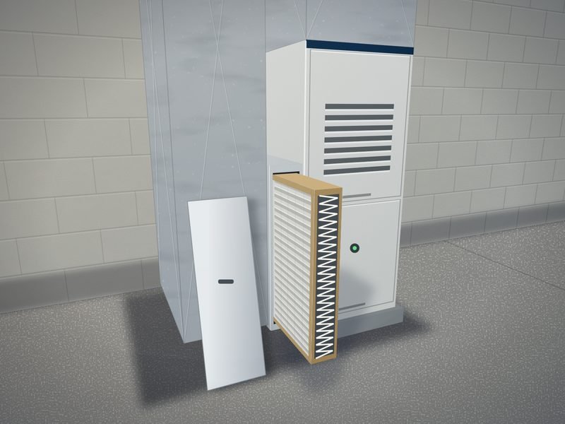 Thick media air filter cabinet on the return side of a furnace with the pleated filter slid halfway out